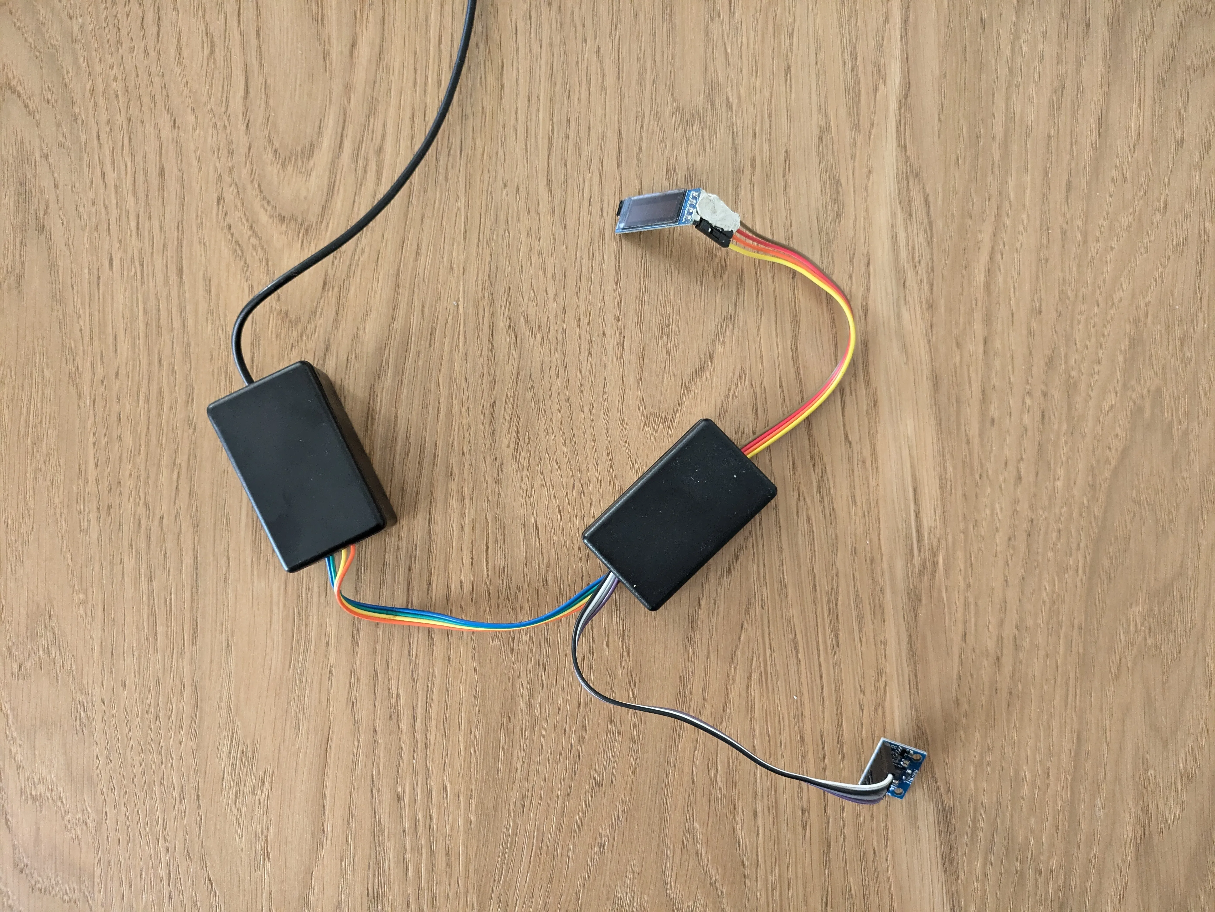 Various pieces of the espresso shot timer including Wemos D1 Mini, OLED display and vibration sensor